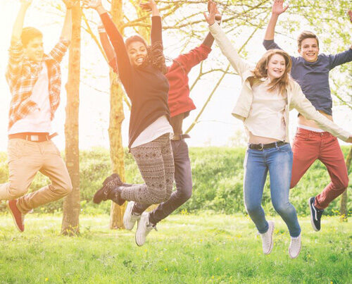 children jumping in a forest