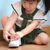 young girl tying shoelaces